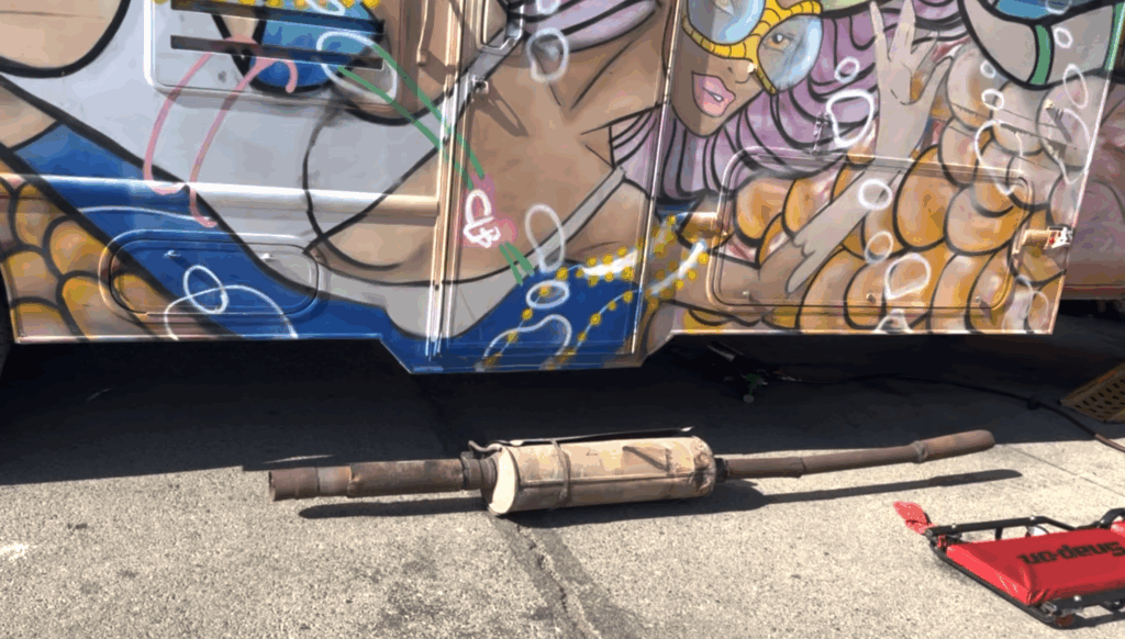 Mechanic rebuilding custom exhaust system on RV in El Paso to fix carbon monoxide leak.